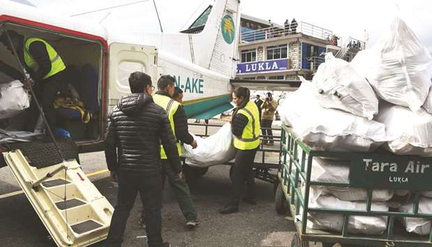 Airline staff load waste collected from the Everest region at Lukla Airport, the gateway to the area, in Lukla, as it is transported to Kathmandu to be recycled.