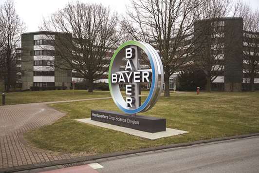 A logo stands outside Bayeru2019s CropScience facility in Monheim, Germany. Bayer and Monsanto must still convince US regulators who are pushing for the companies to divest more assets to resolve antitrust concerns, a person familiar with the probe said.