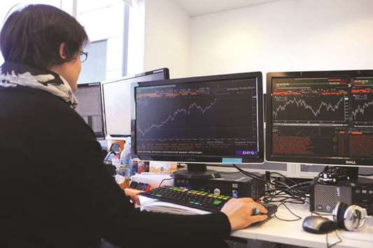 A trader is seen at the London Stock Exchange. The FTSE 100 index closed 0.3% down at 7,038.97 yesterday.