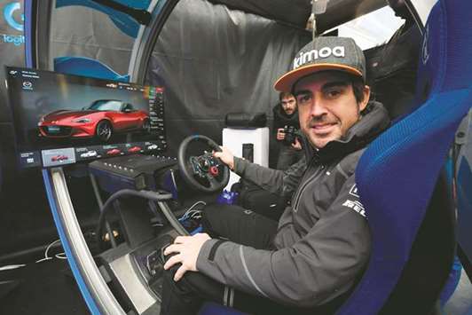 McLarenu2019s Spanish driver Fernando Alonso sits at the Logitech virtual reality simulator at the Mobile World Congress (MWC), the worldu2019s biggest mobile fair in Barcelona.  File photo