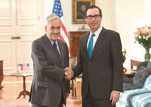 Chileu2019s President Sebastian Pinera shakes hands with US Treasury Secretary Steven Mnuchin during a meeting at Palacio de la Moneda in Santiago yesterday.