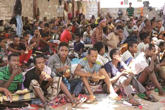 African migrants sit in a deportation centre in Aden, Yemen.