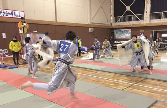BATTLE: Participants in Japanu2019s annual pillow-fighting tournament battle it out while wearing yukata.