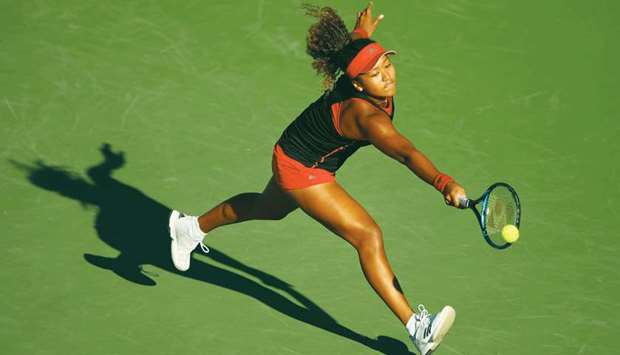 Naomi Osaka of Japan stretches to play a backhand against Serena Williams of the United States in their first round match during the Miami Open at Crandon Park Tennis Centre in Key Biscayne, Florida. (Getty Images/AFP)