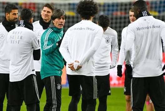 Germanyu2019s coach Joachim Loew talks to the players during a training session ahead of their international friendly match against Spain at Paul-Janes-Stadion in Duesseldorf,  western Germany. (AFP)