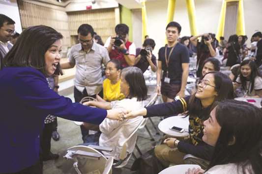 Chief Justice Sereno shakes hands with a student during the u2018Women vs Strongman: Filipinas Resistingu2019 forum at the University of the Philippines in Manila yesterday. The chief justice has vowed to fight bullyingu2019 and save judicial independence as President Rodrigo Duterteu2019s congressional allies launched an impeachment process to remove her from office.