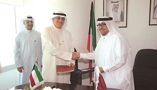 Hassan al-Ibrahim (right) and Jassim al-Habib at the MoU signing ceremony in Kuwait City.
