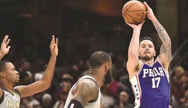 Philadelphia 76ersu2019 JJ Redick (right) shoots over Cleveland Cavaliersu2019 Rodney Hood (left) and LeBron James during the NBA game in Cleveland on Thursday. (USA TODAY Sports)
