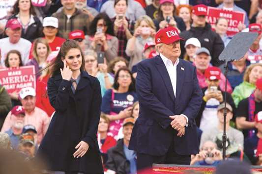 Donald Trump and Hope Hicks stand on stage during a u2018Thank You Tour 2016u2019 rally on December 17, 2016 in Mobile, Alabama.