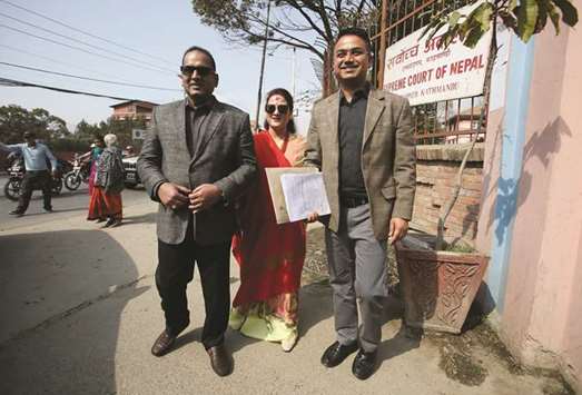 Kailash Sirohiya, chairman and publisher of Kantipur Daily, groupu2019s director Swastika Sirohiya, centre, and editor Sudheer Sharma, right, stand together near the Supreme Court of Nepal after being summoned to appear by the chief justice in Kathmandu yesterday.