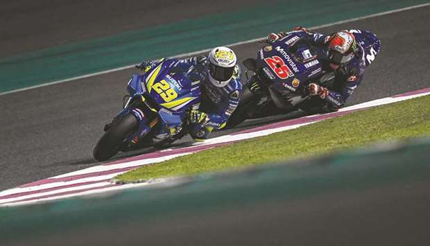 Andrea Iannone of Team Suzuki (left) and Maverick Vinales of Yamaha rider in action during the second day of the MotoGP pre-season testing at Losail International Circuit yesterday.