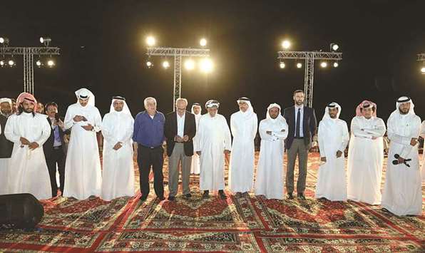 HE the Minister of Culture and Sports Salah bin Ghanem bin Nasser al-Ali with officials at World Poetry Day event.