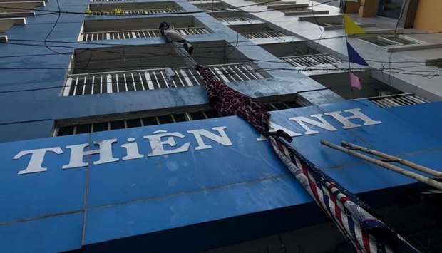 Improvised escape materials hang from a balcony at an apartment building after a fire broke out in Vietnam's southern commercial hub of Ho Chi Minh City