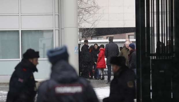 Members of the British embassy staff gather at its compound in Moscow, Russia