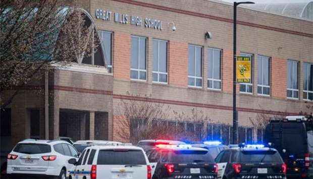 Law enforcement vehicles are parked in front of the Great Mills High School in Great Mills, Maryland after a shooting at the school on Tuesday.