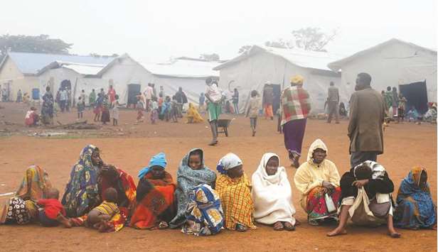 Congolese families, who fled from Democratic Republic of Congo on a boat across Lake Albert, sit in a queue at United Nations High Commission for Refugeesu2019 (UNHCR) Kyangwali refugee settlement camp, Uganda.