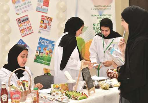 Graduate dietitians advising visitors on the salt content in their daily diet.