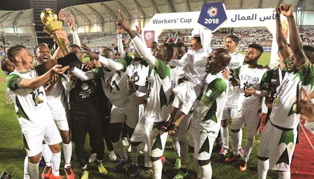 Al Nakheel Landscapes players celebrate with the trophy after winning the Workersu2019 Cup at the Al Duhail Stadium yesterday. PICTURES: Shaji Thottathil