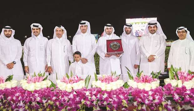   Qatar Racing and Equestrian (QREC) general manager Nasser Sherida al-Kaabi (second from right) and QREC deputy chief steward Abdulla Rashid al-Kubaisi (right) with the guests during the presentation ceremony of the Late Yousef al- Romaihi Cup at the QREC on Thursday. PICTURE: Juhaim