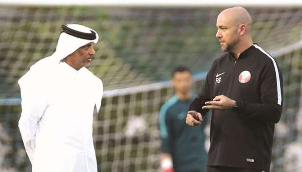 Qatar Football Association President Sheikh Hamad bin Khalifa bin Ahmed al-Thani interacting with coach Felix Sanchez yesterday.