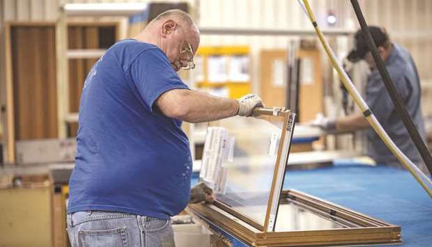 A worker installs glass to a window frame at the Pella Corp manufacturing facility in Pella, Iowa. Core capital goods orders in the US increased 7.4% on a year-on-year basis. Shipments of core capital goods increased 1.4% last month, the biggest advance since December 2016, after an upwardly revised 0.1% gain in January.