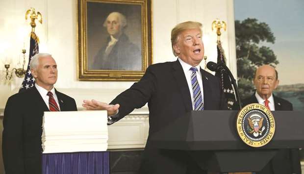 Trump pats Congressu2019 $1.3tn omnibus spending bill with Vice-President Mike Pence (left) and Commerce Secretary Wilbur Ross at his side during a press conference at the Diplomatic Room of the White House.