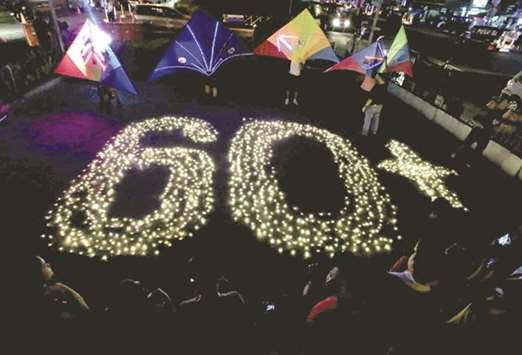 Light lamps form the number 60, representing the 60 minutes of Earth Hour, during Earth Hour outside a mall in Bacoor, Cavite city, south of Manila, yesterday.