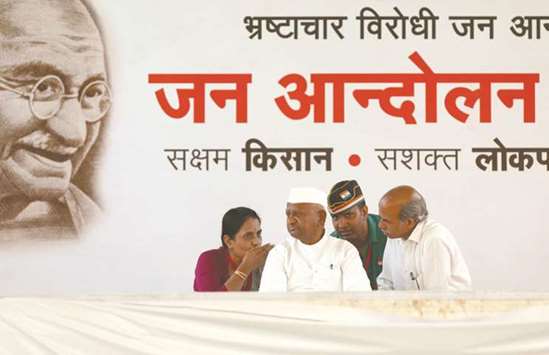 Anna Hazare speaks with his supporters on the second day of his hunger strike at Ramlila ground in New Delhi yesterday.