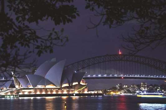 Sydney Harbour Bridge and the Opera House are plunged into darkness for the Earth Hour environmental campaign, yesterday.