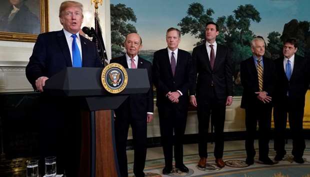 US President Donald Trump, flanked by ?Commerce Secretary Wilbur Ross, US Trade Representative Robert Lighthizer, White House Homeland Security Advisor Tom Bossert, Assistant to the President Peter Navarro and Deputy Assistant to the President for International Economic Affairs Everett Eissenstat, delivers remarks before signing a memorandum on intellectual property tariffs on high-tech goods from China, at the White House in Washington, US