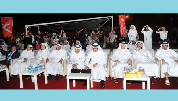 HE Dr Mohamed bin Saleh al-Sada and Issa bin Hilal al-Kuwari switching off lights to mark the Earth Day celebrations at Kahramaa Awareness Park yesterday. PICTURE: Jayan Orma
