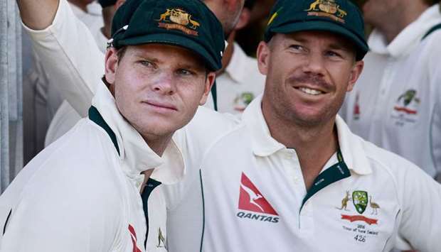 Steve Smith (L) captain of Australia and teammate David Warner (R) wait to start the days play during day one of the second cricket Test match between New Zealand and Australia at the Hagley Park in Christchurch. February 20, 2016 file picture. AFP