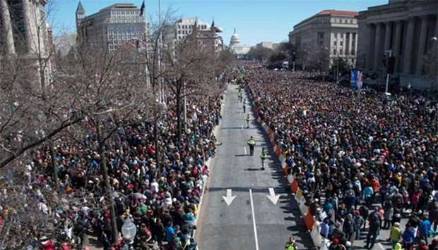 People take part in the March For Our Lives rally against gun violence in Washington, DC on Saturday.
