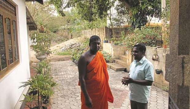 Abdul Saleel Mohamed Fazil and monk Gerandigala Chanda Wimala look on at the monku2019s residence in Digana in this picture taken on March 16.