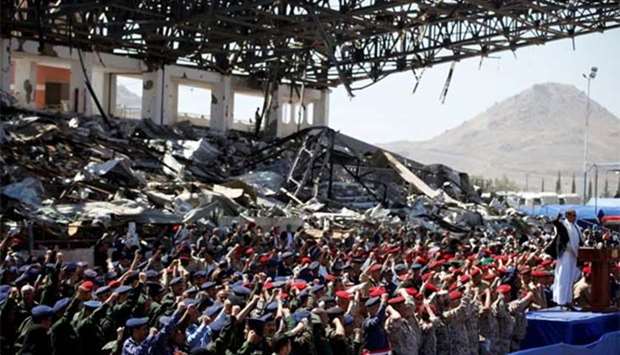 Army officers allied with the Houthis attend a rally at a parade square damaged by air strikes to mark the third anniversary of the Saudi-led intervention in the Yemeni conflict in Sanaa on Monday.