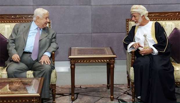 Oman's Foreign Minister Yussef bin Alawi meets with his Syrian counterpart Walid al-Muallem in Muscat on Monday.