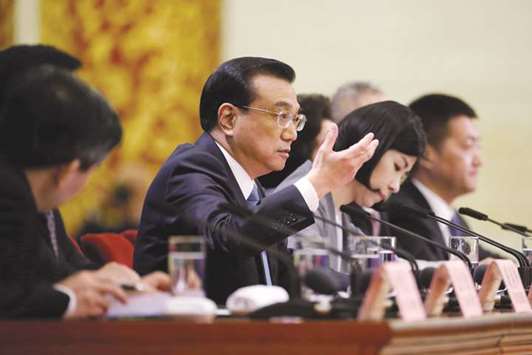 Chinese Premier Li Keqiang speaks at a news conference in Beijing. Li said that China would treat foreign and domestic firms equally, would not force foreign firms to transfer technology and would strengthen intellectual property rights, repeating promises that have failed to placate Washington.