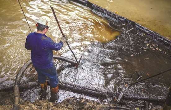 Workers of state-owned oil company Ecopetrol clean the Lizama river which has been affected by an oil leak in Barrancabermeja, Santander department, Colombia. The oil spill from an Ecopetrol inactive oil well has sparked an environmental crisis.