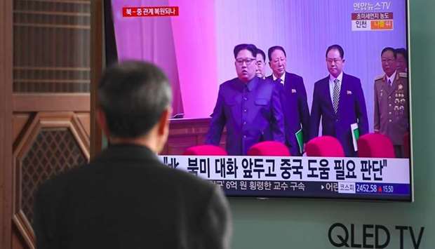 A man watches a television news report about a suspected visit to China by North Korean leader Kim Jong Un, at a railway station in Seoul. AFP
