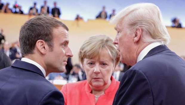 Emmanuel Macron of France and Angela Merkel of Germany talk with Donald Trump. (file picture)