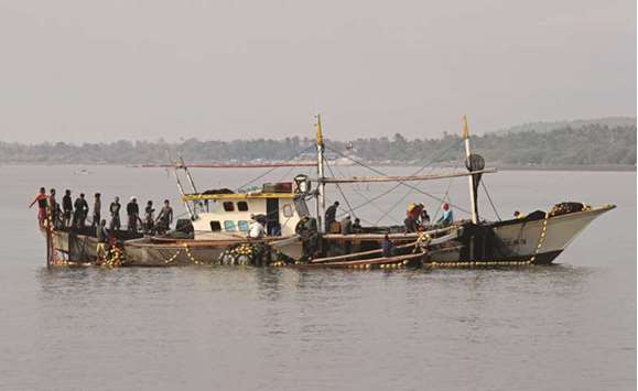 Filipino fishermen sort their nets off the coast of Pinamalayan, Oriental Mindoro.