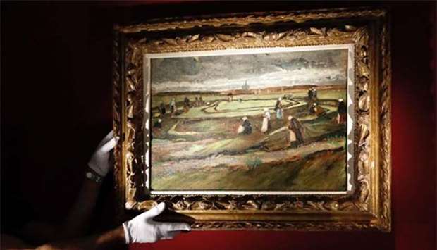 The painting ,Raccommodeuses de filet dans les dunes, by Dutch painter Vincent van Gogh is presented at Artcurial auction house in Paris on Wednesday.