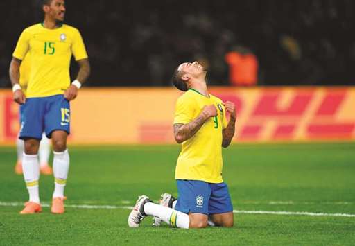 Brazilu2019s forward Gabriel Jesus (right) celebrates after scoring a goal as midfielder Paulinho looks on during their international friendly against Germany in Berlin. (AFP)