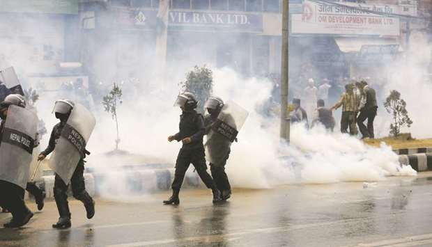 Smoke rises from a teargas shell fired by the police to disperse the crowd during the protest against the road expansion projects causing people in the affected areas to lose their houses and lands in Kathmandu yesterday.