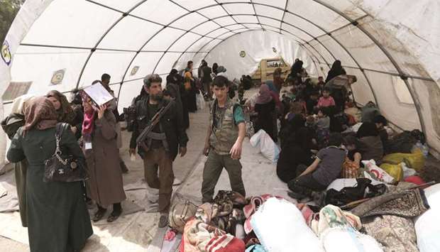 Syrian civilians and rebels evacuated from the Eastern Ghouta region rest in a tent after arriving in Qalaat al-Mandiq, some 45 kilometres northwest of the central city of Hama, yesterday.