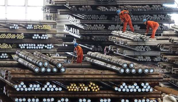 Workers transport steel bars at a plant of Dongbei Special Steel Group Co Ltd. in Dalian, Liaoning province, China 