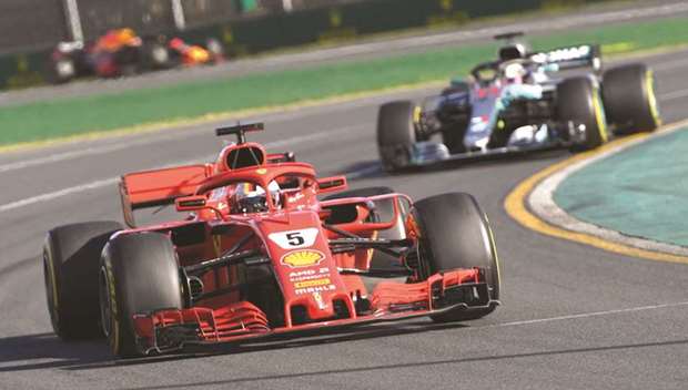 Ferrariu2019s German driver Sebastian Vettel (front) leads Mercedesu2019 British driver Lewis Hamilton during the Formula One Australian Grand Prix in Melbourne. (w)