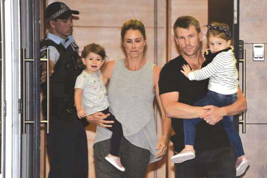 David Warner, his wife Candice and their daughters arrive in Sydney yesterday. (AFP)