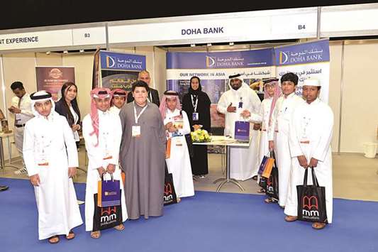 Young visitors at the Doha Bank booth during the u2018Education Festivalu2019.