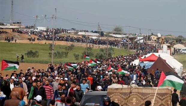 Palestinians attend a tent city protest along the Israel border with Gaza, demanding the right to return to their homeland, east of Gaza City on Friday.